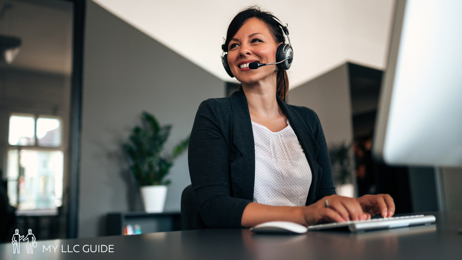 receptionist sitting at desk taking a phone call