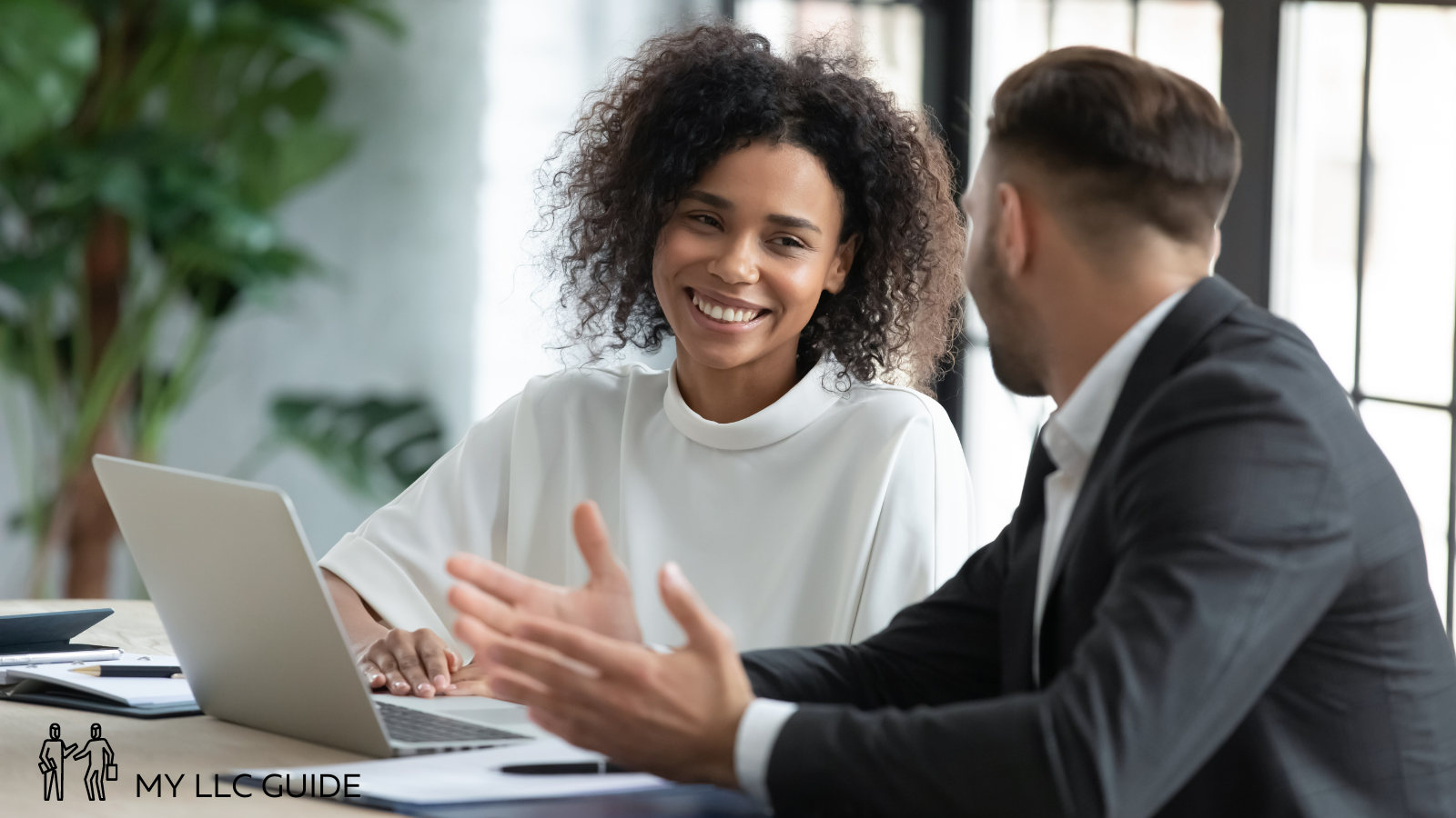 man and woman working together in an office