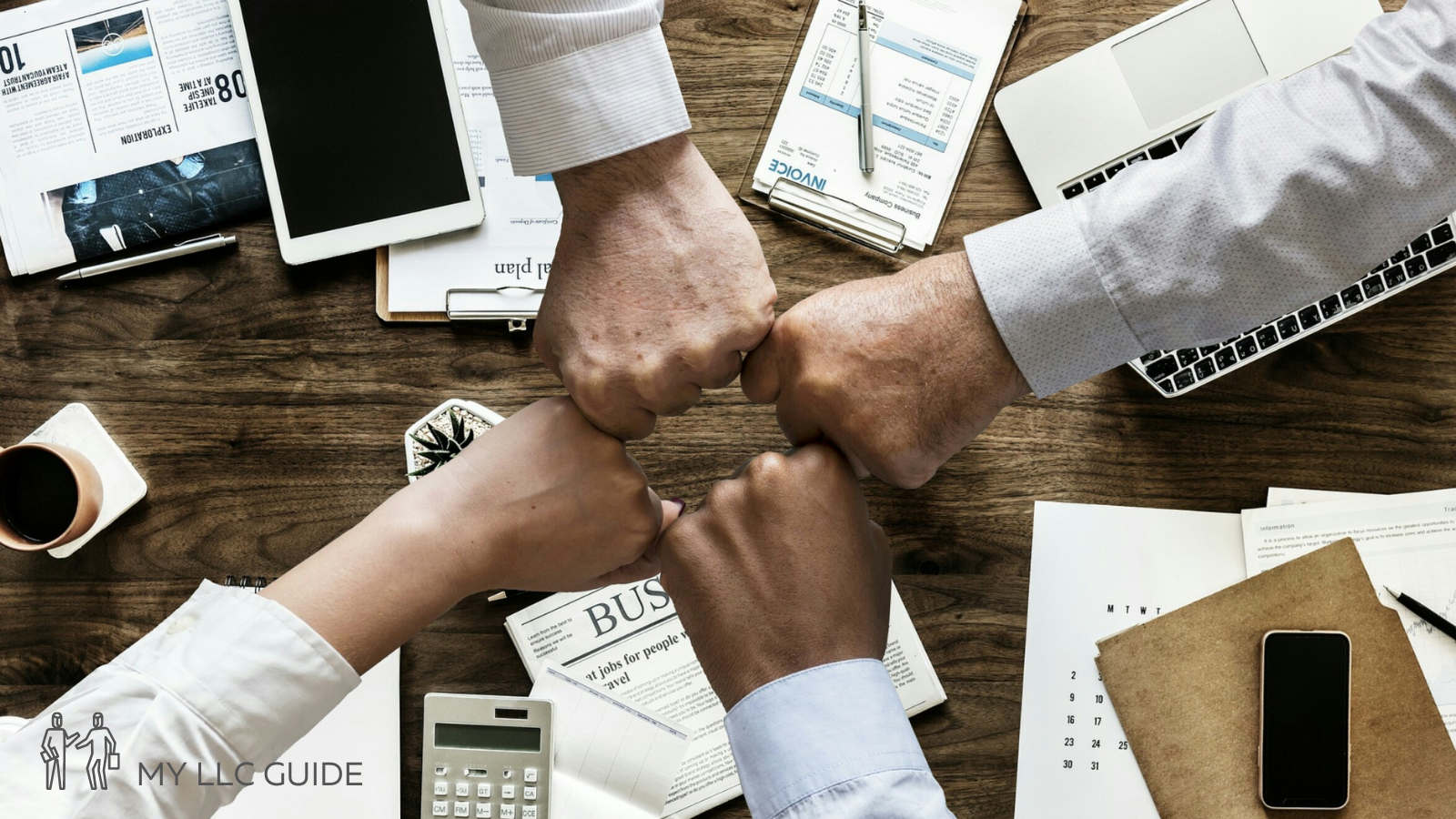 workers making a fist bump in an office