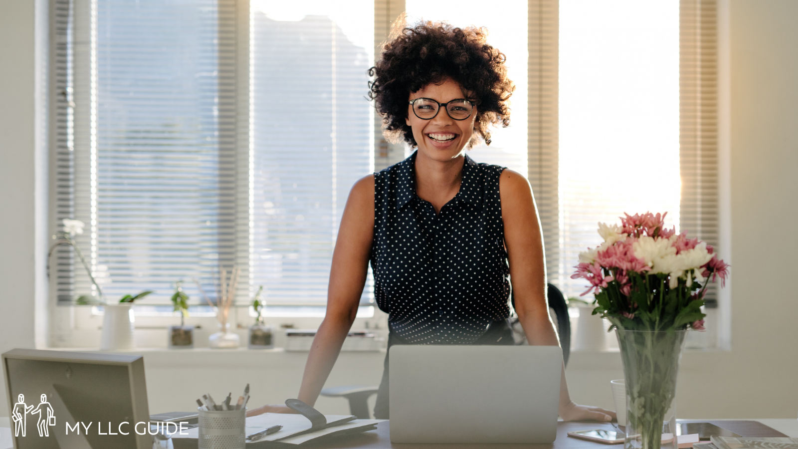 woman standing behind a desk in an LLC company