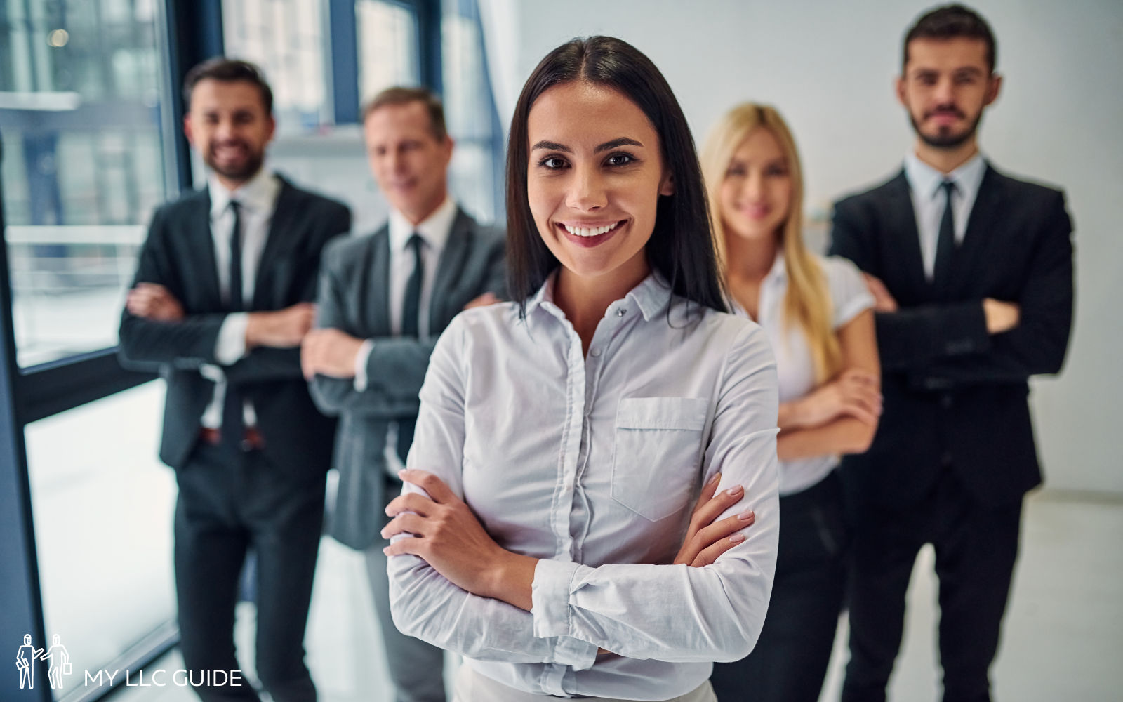 members of a holding company standing in an office